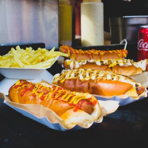 four hotdog sandwiches on desk
